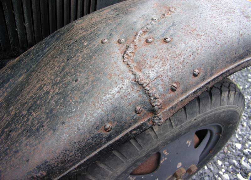 Above Rusty old Ford pickup truck out in back