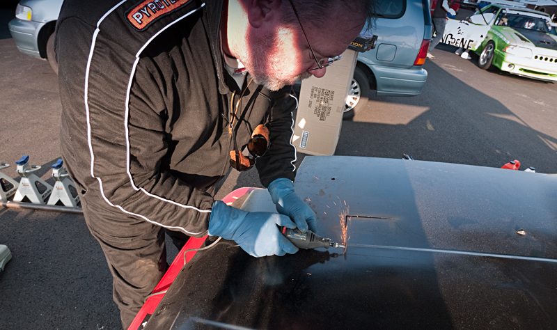 Dr. Chuck surgically modifies the hood of the Integra to allow a cool stream of air to flow over the coil-distributor pack.