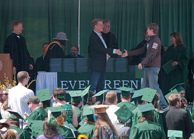 Chris shaking Rick Steves' hand after receiving his diploma.