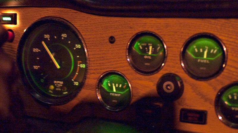 The dash of the TR-6 at night.